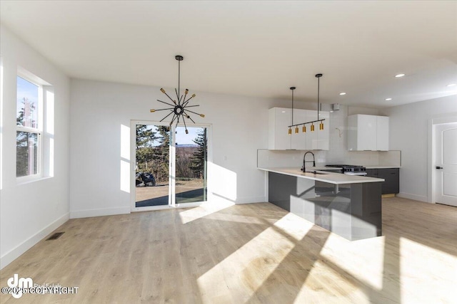 1866 S Rolling Hills St, Wasilla, AK 99623 - kitchen featuring white cabinetry, light countertops, baseboards, modern cabinets, and backsplash