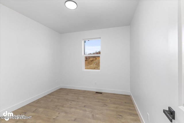 1866 S Rolling Hills St, Wasilla, AK 99623 - unfurnished room featuring baseboards and light wood-style floors