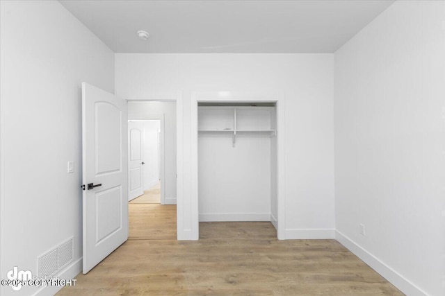 1866 S Rolling Hills St, Wasilla, AK 99623 - unfurnished bedroom featuring a closet, light wood-type flooring, and baseboards
