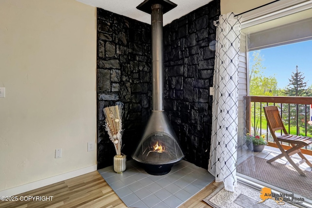 4640 Reka Dr Unit 19, Anchorage, AK 99508 - detailed view of a wood stove, wood finished floors, and baseboards