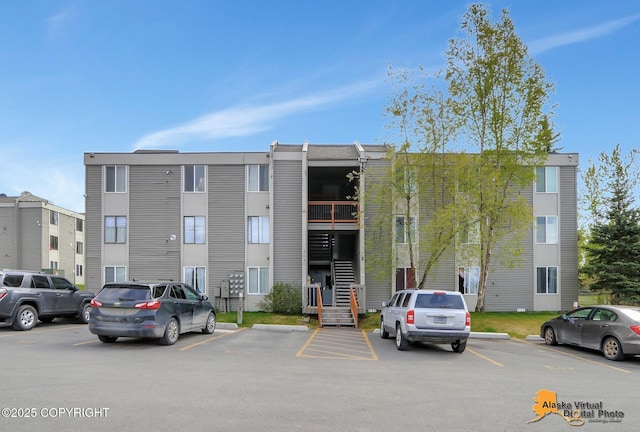 4640 Reka Dr Unit 19, Anchorage, AK 99508 - view of building exterior featuring uncovered parking