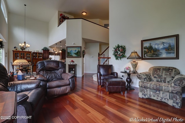10885 Splendor Loop, Eagle River, AK 99577 - living area with a chandelier, wood finished floors, high vaulted ceiling, stairs, and baseboards