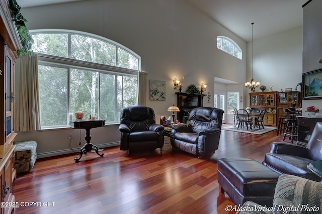 10885 Splendor Loop, Eagle River, AK 99577 - living area featuring a chandelier, wood finished floors, and high vaulted ceiling