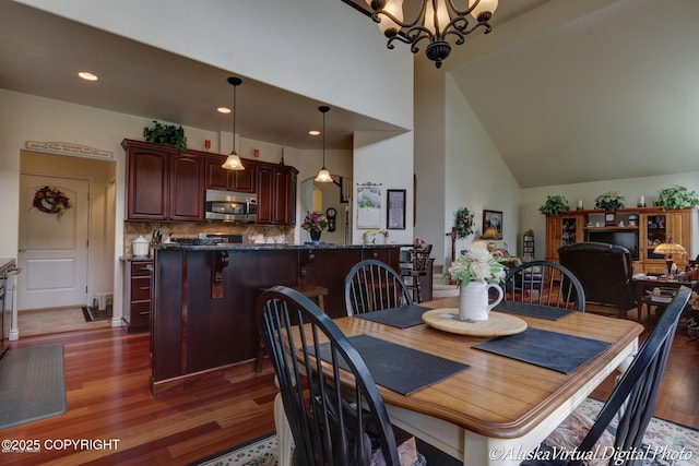 10885 Splendor Loop, Eagle River, AK 99577 - dining room with dark wood finished floors, a towering ceiling, a chandelier, and recessed lighting