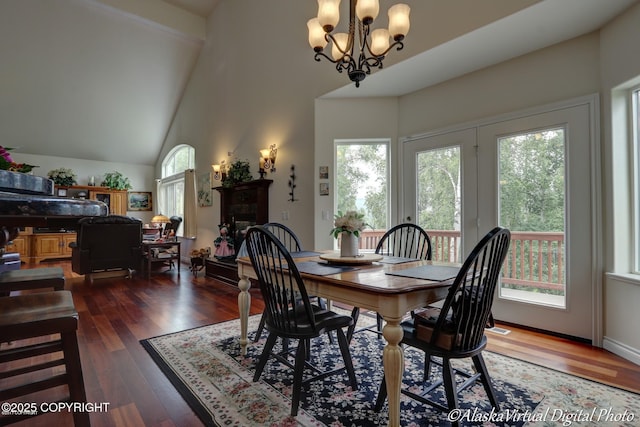 10885 Splendor Loop, Eagle River, AK 99577 - dining room featuring high vaulted ceiling, hardwood / wood-style flooring, a chandelier, and a fireplace