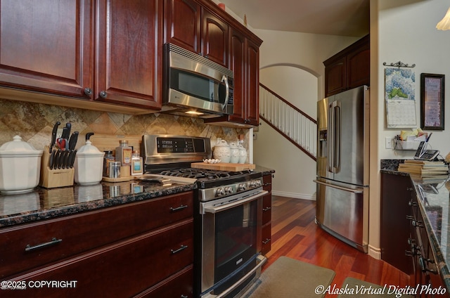 10885 Splendor Loop, Eagle River, AK 99577 - kitchen featuring appliances with stainless steel finishes, dark wood finished floors, decorative backsplash, and dark brown cabinets