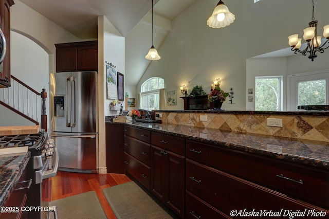 10885 Splendor Loop, Eagle River, AK 99577 - kitchen featuring appliances with stainless steel finishes, dark wood-type flooring, pendant lighting, a chandelier, and decorative backsplash