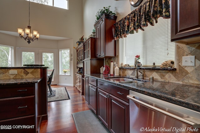 10885 Splendor Loop, Eagle River, AK 99577 - kitchen with stainless steel dishwasher, a sink, healthy amount of natural light, tasteful backsplash, and a high ceiling