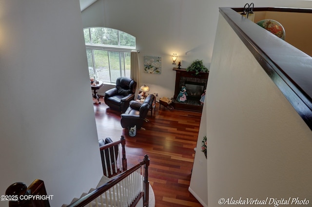 10885 Splendor Loop, Eagle River, AK 99577 - staircase with wood finished floors, a high ceiling, and a glass covered fireplace