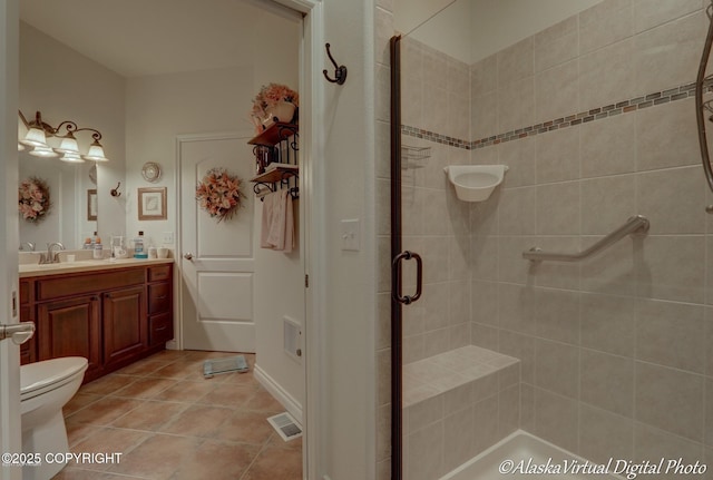 10885 Splendor Loop, Eagle River, AK 99577 - full bathroom featuring a stall shower, vanity, toilet, and tile patterned floors
