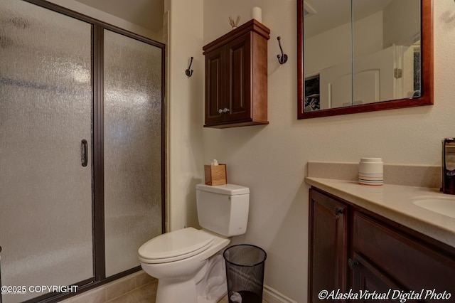 10885 Splendor Loop, Eagle River, AK 99577 - full bathroom with vanity, toilet, a shower stall, tile patterned floors, and baseboards