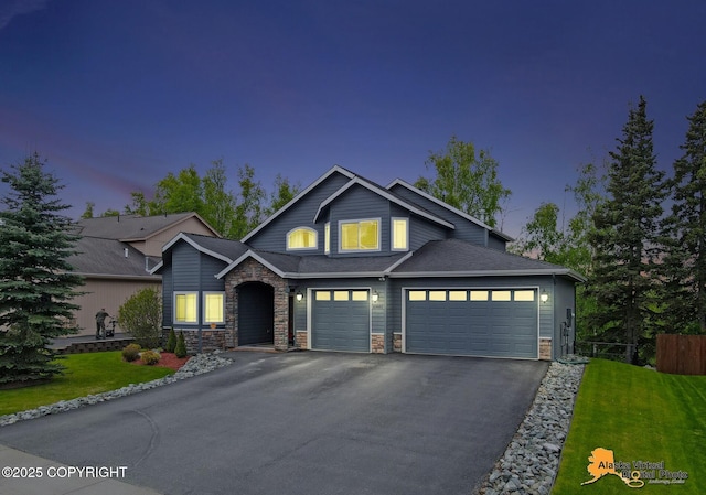 10885 Splendor Loop, Eagle River, AK 99577 - view of front of property featuring stone siding, driveway, and an attached garage