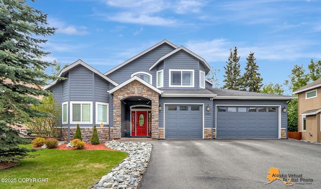 10885 Splendor Loop, Eagle River, AK 99577 - view of front of property with stone siding, driveway, a front lawn, and a garage