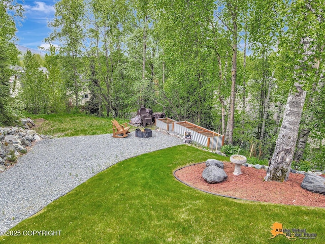 10885 Splendor Loop, Eagle River, AK 99577 - view of green lawn featuring a patio