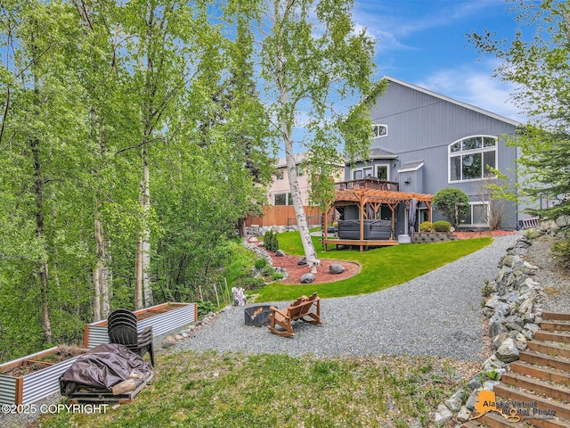 10885 Splendor Loop, Eagle River, AK 99577 - back of house with a jacuzzi, a fire pit, a deck, and a patio