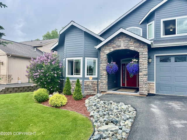 10885 Splendor Loop, Eagle River, AK 99577 - craftsman-style home with stone siding, asphalt driveway, and a front lawn