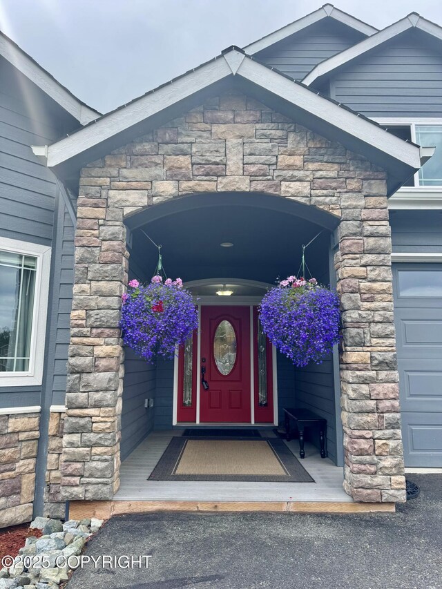 10885 Splendor Loop, Eagle River, AK 99577 - view of exterior entry featuring stone siding