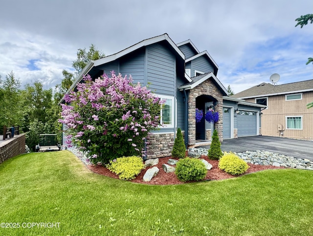 10885 Splendor Loop, Eagle River, AK 99577 - view of front of property featuring stone siding, an attached garage, driveway, and a front yard