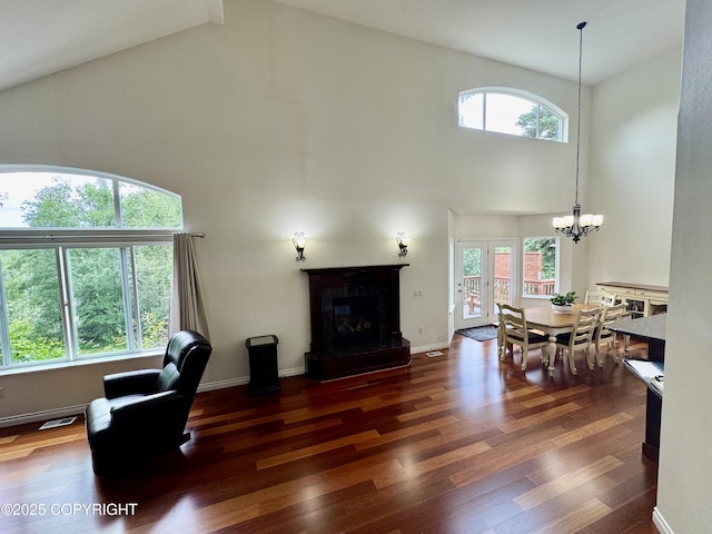 10885 Splendor Loop, Eagle River, AK 99577 - living room with high vaulted ceiling, a chandelier, wood finished floors, and a premium fireplace