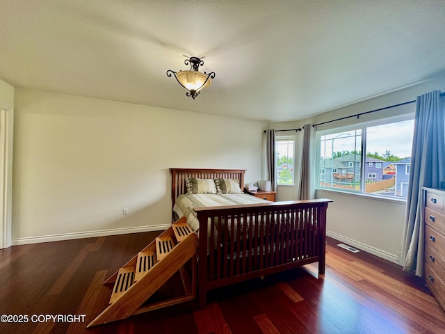 10885 Splendor Loop, Eagle River, AK 99577 - bedroom featuring wood finished floors and baseboards