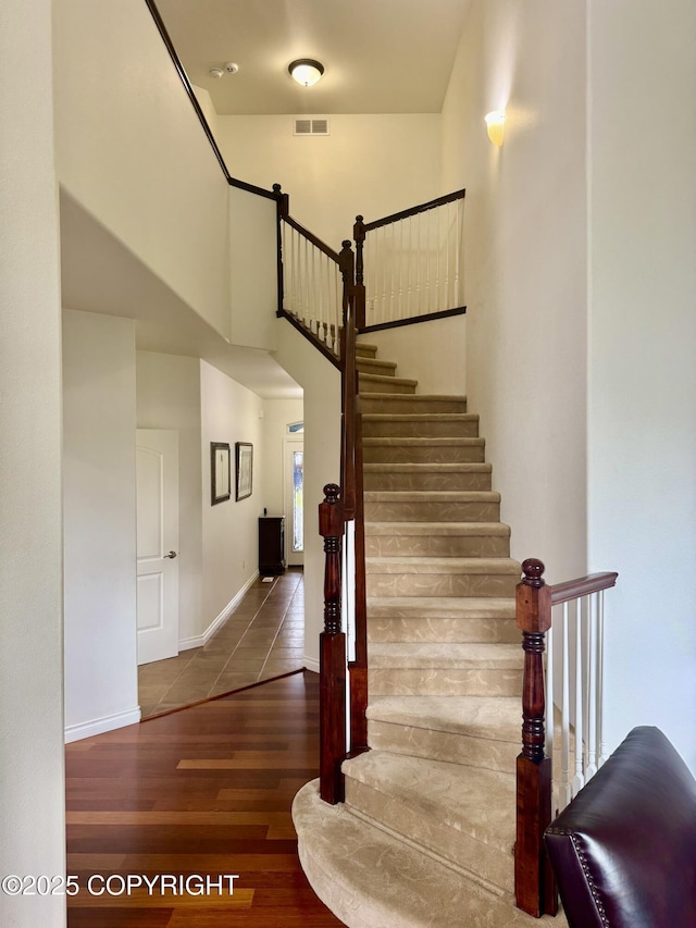 10885 Splendor Loop, Eagle River, AK 99577 - staircase with wood finished floors and a towering ceiling