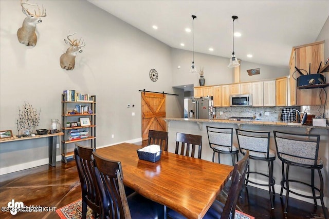 37638 Dutch Landing Loop, Sterling, AK 99672 - dining area featuring a barn door, concrete flooring, baseboards, high vaulted ceiling, and recessed lighting