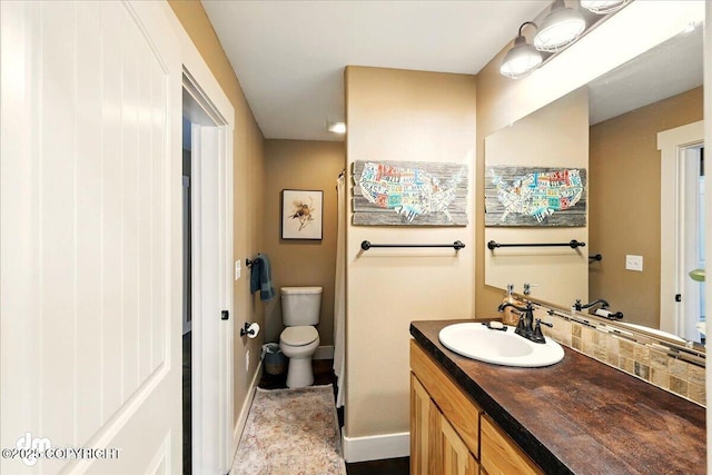 37638 Dutch Landing Loop, Sterling, AK 99672 - bathroom featuring toilet, vanity, and baseboards