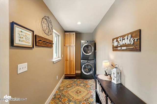 37638 Dutch Landing Loop, Sterling, AK 99672 - washroom featuring cabinet space, stacked washing machine and dryer, and baseboards