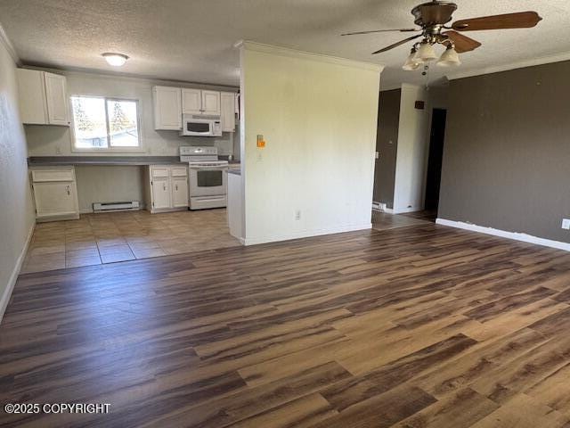 180 Grand Larry St Unit B6, Anchorage, AK 99504 - kitchen featuring electric range oven, ornamental molding, white microwave, open floor plan, and a baseboard heating unit