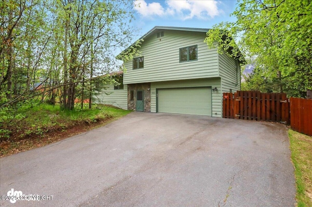 19254 Adak Cir, Eagle River, AK 99577 - view of front of house featuring an attached garage and driveway