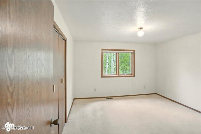 19254 Adak Cir, Eagle River, AK 99577 - unfurnished bedroom with baseboards, a closet, and a textured ceiling