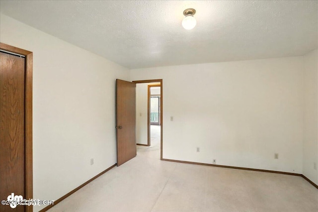 19254 Adak Cir, Eagle River, AK 99577 - unfurnished room with baseboards, light colored carpet, and a textured ceiling