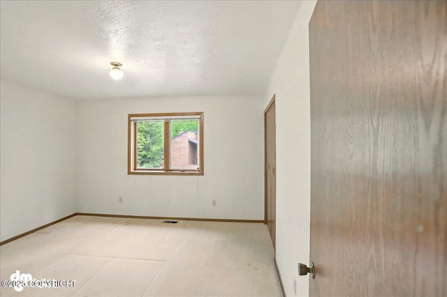 19254 Adak Cir, Eagle River, AK 99577 - empty room featuring light colored carpet, baseboards, and a textured ceiling