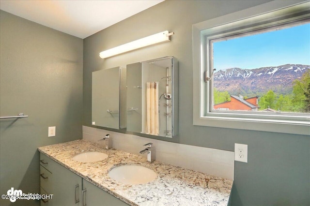 19254 Adak Cir, Eagle River, AK 99577 - bathroom featuring tasteful backsplash and double vanity