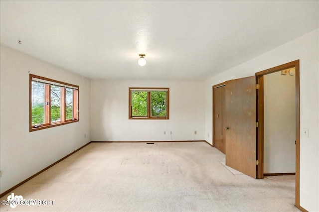 19254 Adak Cir, Eagle River, AK 99577 - unfurnished room featuring plenty of natural light, light carpet, and baseboards