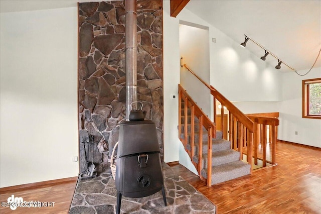 19254 Adak Cir, Eagle River, AK 99577 - stairway with a wood stove, wood finished floors, track lighting, and baseboards