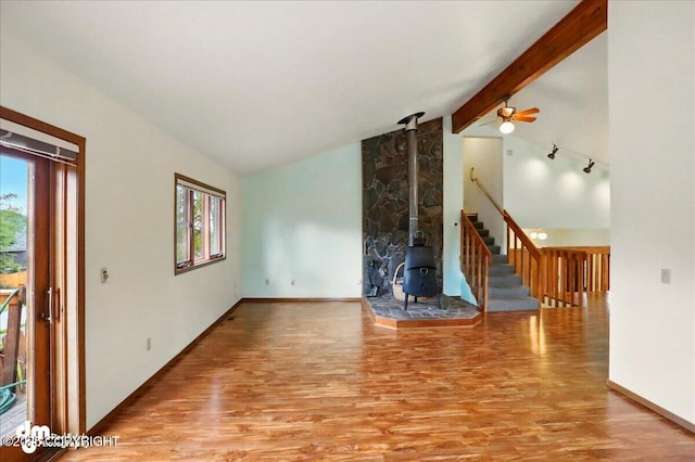 19254 Adak Cir, Eagle River, AK 99577 - unfurnished living room with healthy amount of natural light, wood finished floors, and a wood stove