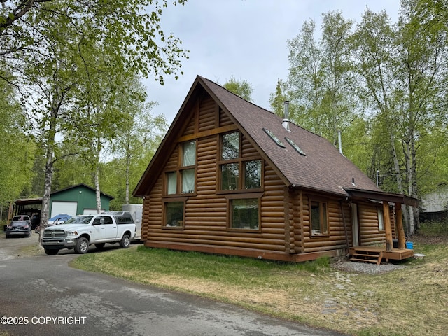601 W Gail Dr, Wasilla, AK 99654 - view of front of property with roof with shingles, a garage, an outbuilding, and log siding