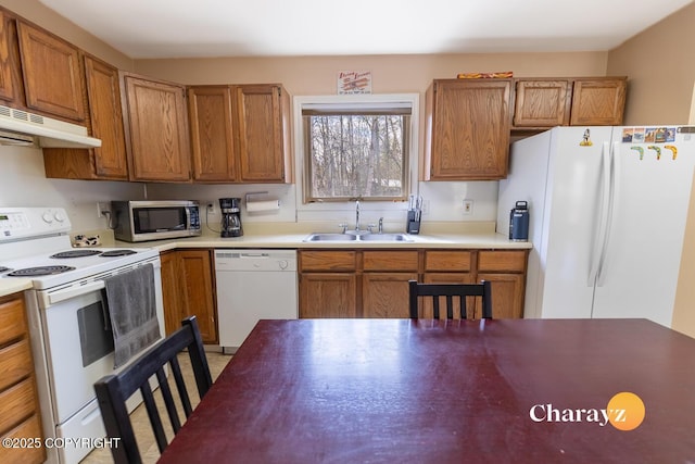 1147 Choctaw Rd, North Pole, AK 99705 - kitchen with white appliances, a sink, under cabinet range hood, and brown cabinets