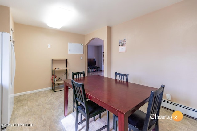 1147 Choctaw Rd, North Pole, AK 99705 - dining room featuring arched walkways and a baseboard heating unit