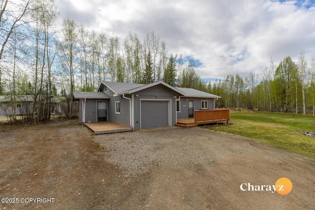 1147 Choctaw Rd, North Pole, AK 99705 - view of front of property featuring an attached garage, driveway, a deck, a front lawn, and a shingled roof