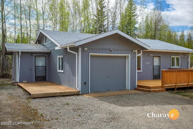 1147 Choctaw Rd, North Pole, AK 99705 - view of front of property featuring a garage, roof with shingles, and a deck