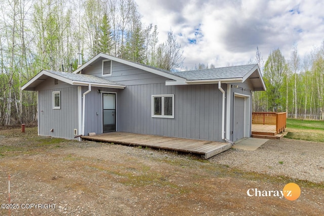 1147 Choctaw Rd, North Pole, AK 99705 - back of house with a wooden deck and a shingled roof