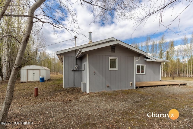 1147 Choctaw Rd, North Pole, AK 99705 - view of property exterior featuring a storage unit, an outdoor structure, and a deck