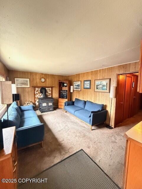 1411 Mission Rd, Kodiak, AK 99615 - carpeted living room with a wood stove and wooden walls