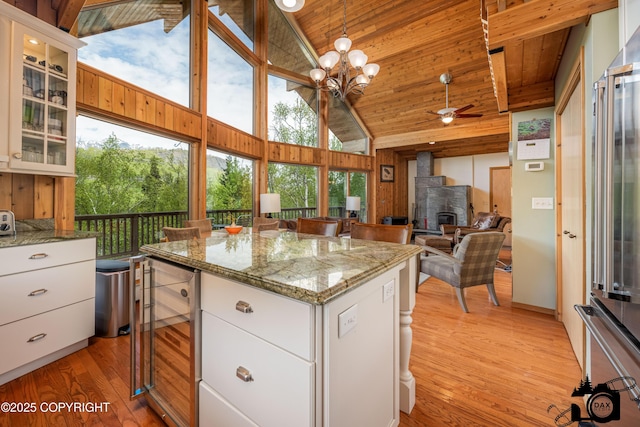 18365 E Twin Hills Ln, Sutton, AK 99645 - kitchen with beverage cooler, light wood-style flooring, a kitchen island, high vaulted ceiling, and ceiling fan