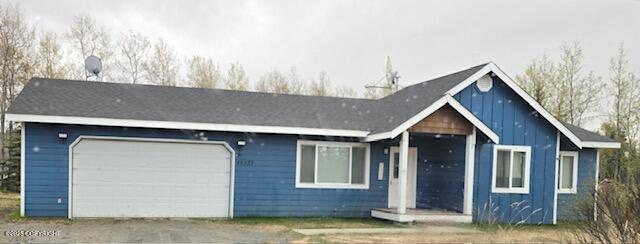 48427 Rustic Ave, Soldotna, AK 99669 - ranch-style home featuring board and batten siding, dirt driveway, and a garage