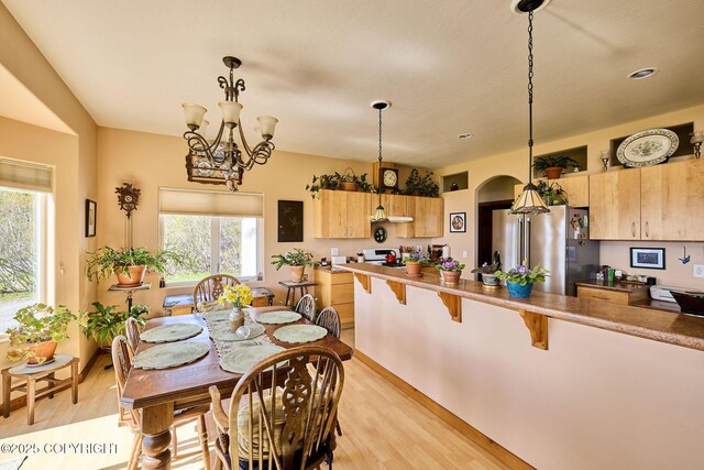 41293 Crested Crane St, Homer, AK 99603 - dining space featuring light wood-style floors, a chandelier, and healthy amount of natural light