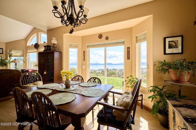 41293 Crested Crane St, Homer, AK 99603 - dining room with light wood finished floors, a chandelier, vaulted ceiling, and baseboards