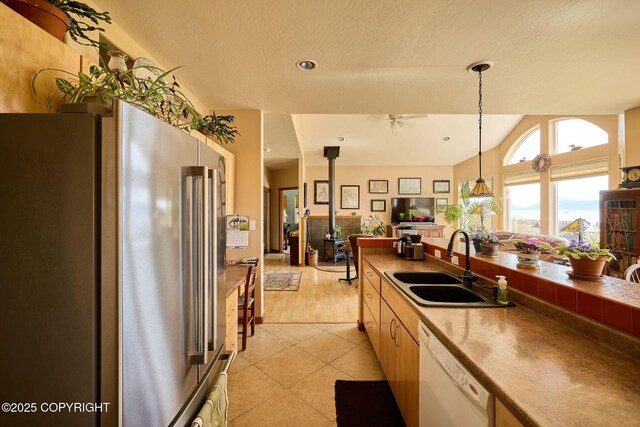 41293 Crested Crane St, Homer, AK 99603 - kitchen with high end refrigerator, dishwasher, a sink, light tile patterned floors, and hanging light fixtures